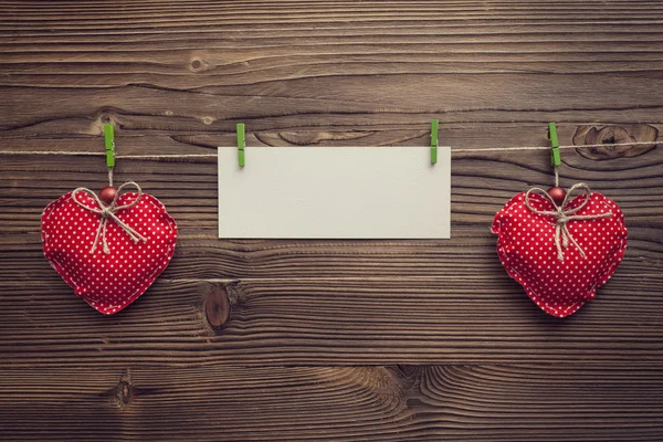 Empty greeting card between xmas hearts — Stock Photo, Image