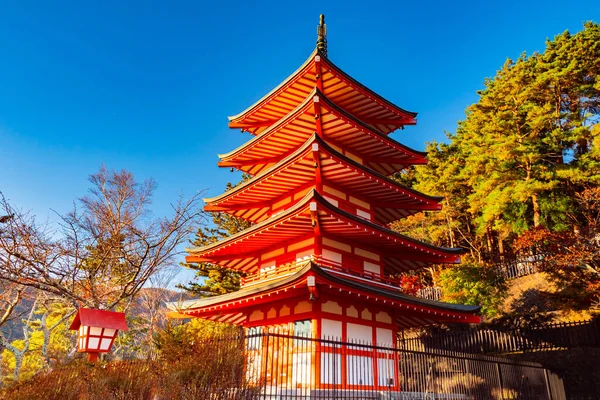 Japan park. Pagoda in Fujiyoshida. Japan pagoda on blue sky background. Excursions to buddism pagoda. Japan park in autumn day. Japanese park on the sky background. Traveling in Japanese.