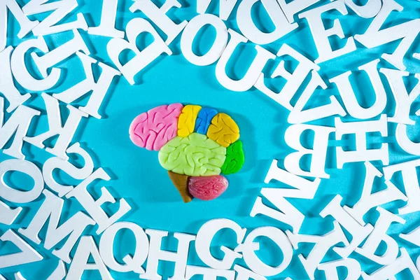 Memory development. Human brain in midst of various letters. Illustration with  brain symbolizes memory training. Teaching person to remember something. Concept - courses on intellectual development