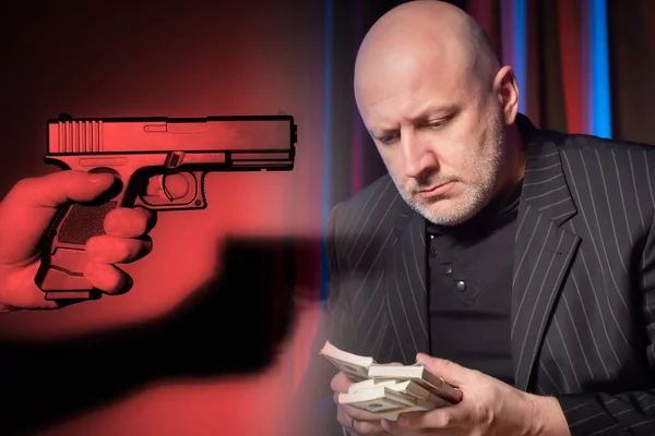 Murder of a businessman. The gun is aimed at a man with money. Hand with a gun. Concept - a killer wants to kill a businessman. Money killing. Concept - murder for robbery. The crime.