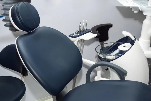 Equipment of the dental office. The chair of the patient and equipment for dental treatment. Drill in the dentist office. Ergonomic furniture for dental clinics.