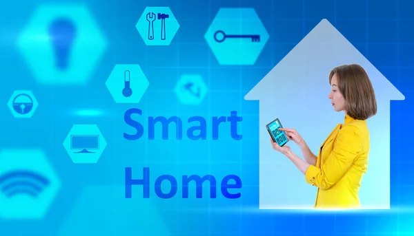 Smart home automation. Businesswoman next to inscription smart home. Control over state of house through a tablet. Concept - she configures IOT automation. Icons symbolizing IOT on a blue background