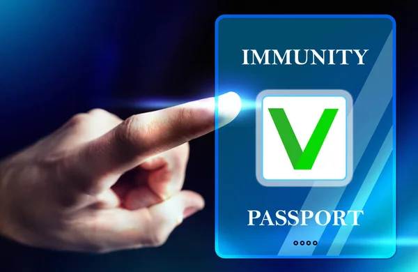 Person puts his finger to the Immune passport label. Passport of immunity or the concept of a risk-free certificate. Confirmation of the presence of antibodies to the coronavirus. Immunity to Covid-19