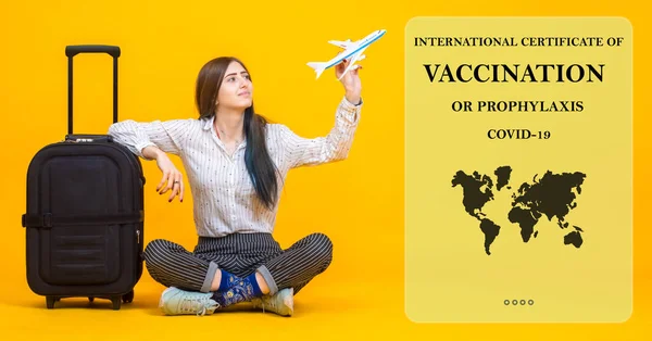 Coronavirus vaccination card. Electronic certificate of vaccination against covid-19. Traveller girl with immune passport. Cancellation of coronavirus quarantine due to vaccination certificate.