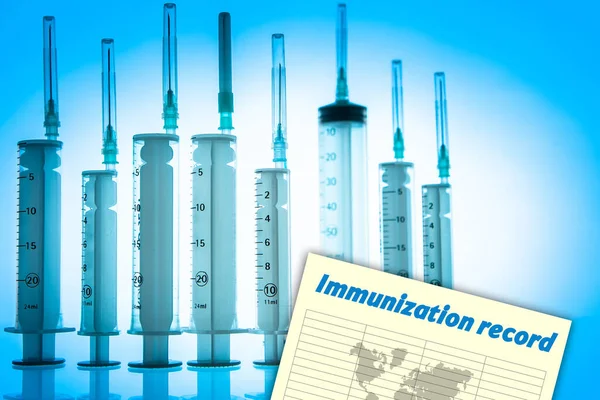 Certificate of vaccination against covid-19. Immunization record as symbol of coronavirus vaccination. Voluntary vaccination. Participation in a covid-19 vaccine trial. Syringes on a blue background