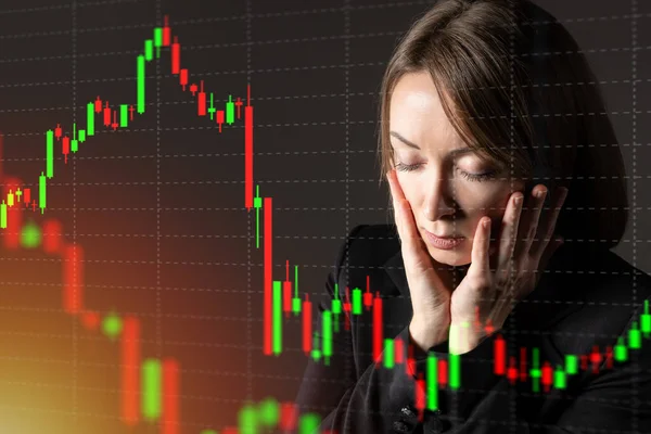 Sad woman investor next to falling graph. She is upset by drop in quotations. Stock value falling concept. Investor is upset by bear market. Portrait of a sad investor. Beginning of crisis