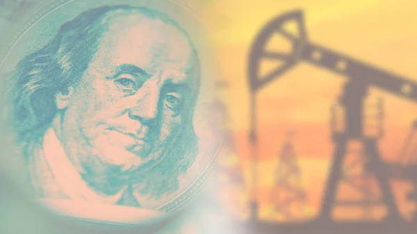 Oil production. Price of crude oil. Petrodollars. An oil rig and a dollar on a blurry background. Mining of natural resources. Fuel industry.