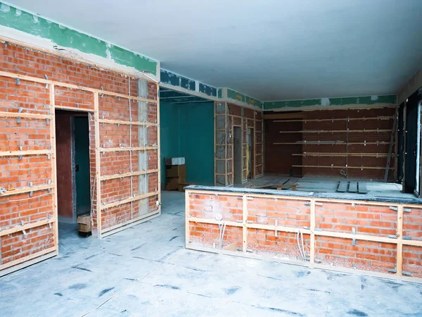 Renovation of the building. Installation of frames for wall panels. Preparation of walls for tiling. Brick walls with wooden frames for facades.