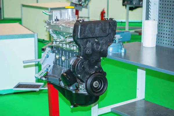 Car motor closeup. Engine is fixed to rack. Car engine repair. concept - inspection of a car engine for breakdowns. Replacement of small parts in auto motor. Elimination of breakdowns in motor.