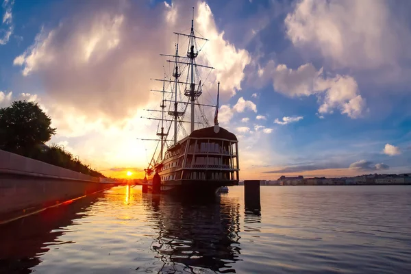 Sailboat on the background of the sunset. Ship with sails on the background of the setting sun and beautiful sky. The sailing ship on the Neva. Sights Of Saint Petersburg.