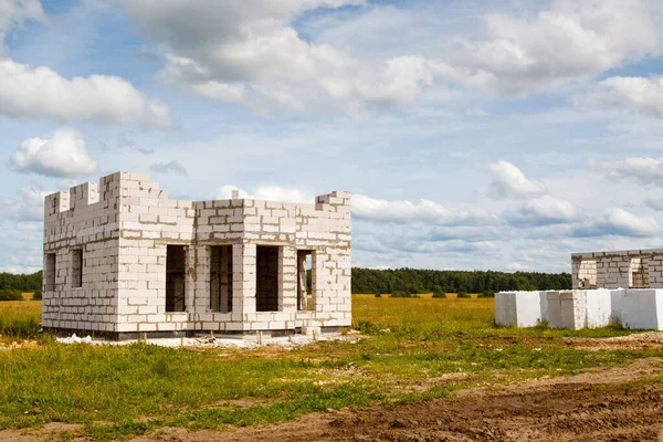 Small building under construction. Building under construction without nobody. House is being built from large penablocks. Building a house from penablock or gas block. Construction of country house