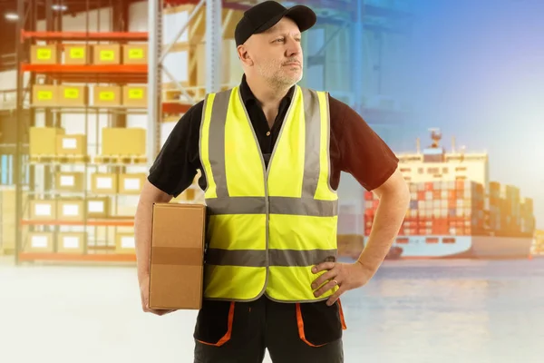 Logistic technologies. Warehouse and logistics services. Storage and dispatch of goods. Logistic services. Logistic company employee. Confident logistician with a box in his hands. Logistician career