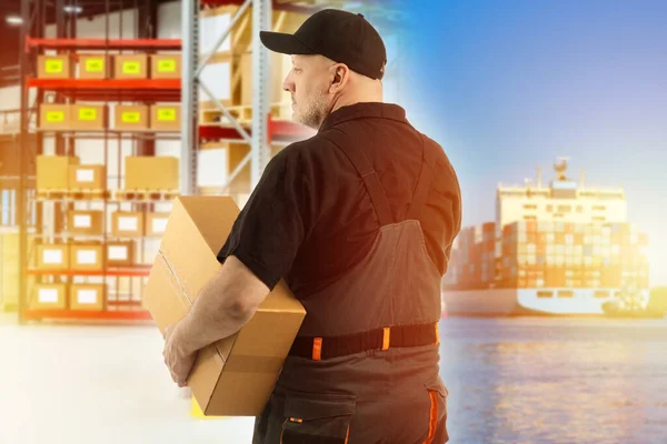 Sending goods by sea. Warehouse worker near ship. Marine logistics. Container ship ship as symbol of sea transportation. Man with box stands with his back to camera. Concept warehouse in seaport.