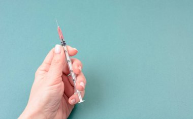 Female hand holds syringe. Coronavirus and flu vaccine concept