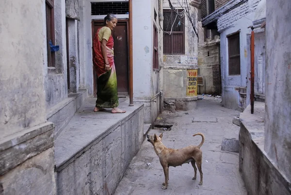 Street scene in gali (narrow pedestrian alleyway) in Varanasi, India.