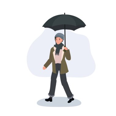 Genç bir yetişkin yağmurlu bir günde elinde şemsiyeyle, soğuk mevsim kıyafetleriyle dışarı çıkar..