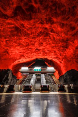Stockholm, Sweden  The fire red interior of the Solna tunnelbana or metro station platform. clipart