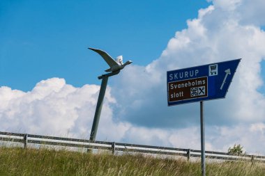 Skurup, Sweden A wild goose, symbol of writer Selma Lagerlof and her character Nils Holgerson who fly across Sweden, stands along the E65 highway in Southern Sweden, clipart