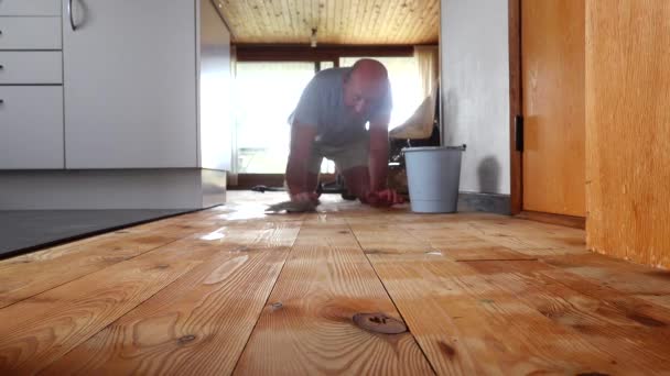 Man Mops Floor His Hands Knees — Stock Video