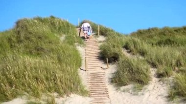 Hirtshals, Danimarka Kuzey Denizi kıyısında bir kadın kumsalda yürüyor..