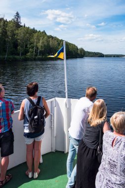 İsveç yolcusu Haverud, Orta İsveç 'in batısındaki Dalsland Kanalı boyunca bir kanal teknesinin pruvasında duruyor..