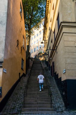 Stockholm, Sweden A person walks up steps at Maria Trappgrand on Sodermalm. clipart
