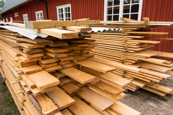 Hofsnas, Sweden Piles of fresh timber piled high waiting for a siding job.