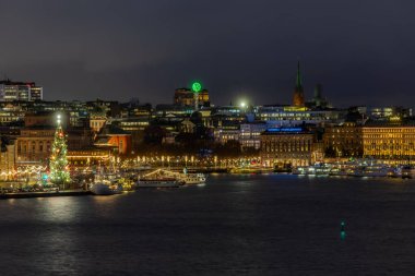 Stockholm, Sweden Dec 13, 2025 Gamla Stan or Old Town at night with a Christmas tree.