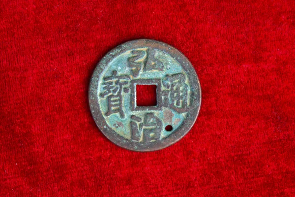 Chinaese ancient money on the red background — Stock Photo, Image