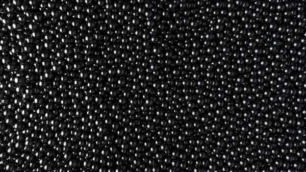 Schwarzer Glanz Kugeln Hintergrund. Hochglanzkugeln füllen das Volumen. Luxus schwarzer Kaviar fließt. 3D-Darstellung. — Stockfoto