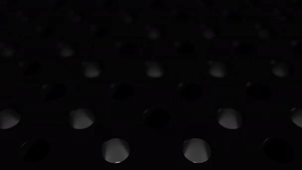 White glowing spheres jump from one hole to another. Dark reflective surface with holes and bouncing balls. 3D looped animation abstract render. Minimal black motion design with depth of field. — Stock Video