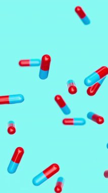Mavi, kırmızı kapsüller yavaşça mavi arkaplana çarpıyor. İlaçlar, haplar, haplar, ilaç konsepti. 3d canlandırma döngüsü oluşturulabilir.