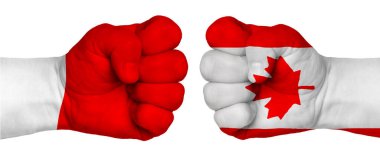 İnsanların mücadelesi kavramı. İki el birbirine kenetlenir ve birbirlerinin karşısındadır. Ülkelerin bayraklarının renklerine boyanmış eller. Kanada ve Polonya