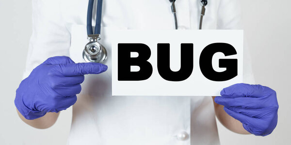 Medicine and health concept. The doctor points his finger at a sign that says - BUG