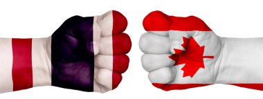 İnsanların mücadelesi kavramı. İki el birbirine kenetlenir ve birbirlerinin karşısındadır. Ülkelerin bayraklarının renklerine boyanmış eller. Kanada Tayland 'a Karşı