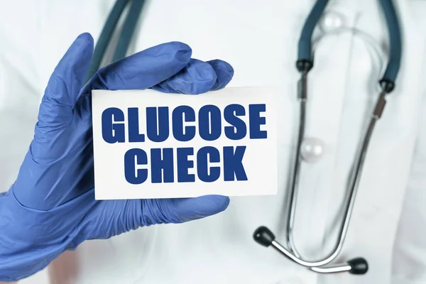 Medicine concept. The doctor holds a business card that says - GLUCOSE CHECK
