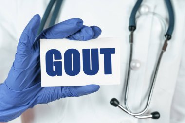 Tıp konsepti. Doktorun elinde gut yazan bir kartvizit var.