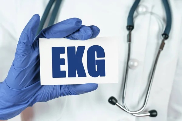 Medicine concept. The doctor holds a business card that says - EKG