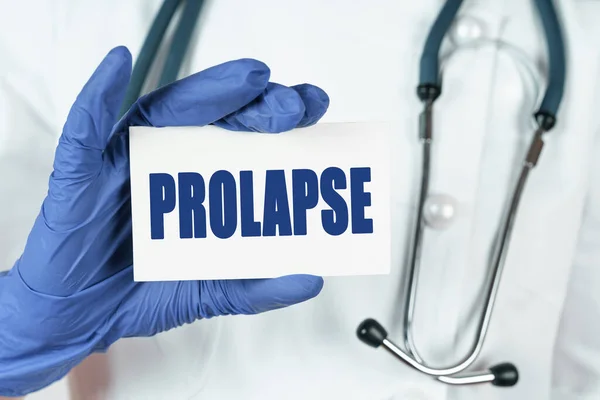 Medicine concept. The doctor holds a business card that says - PROLAPSE