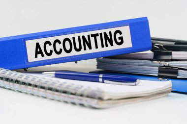 Business and finance concept. On the table are a notebook, a pen, documents and a folder with the inscription - ACCOUNTING