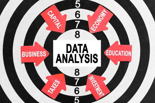 Business and finance concept. On the target, arrows with business lettering point to the center on a business card with the inscription - DATA ANALYSIS