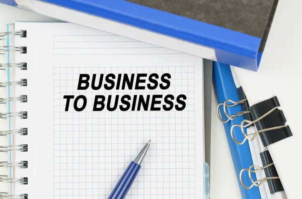 Business and Economics. Among the documents, folders, a notebook with the inscription - BUSINESS TO BUSINESS