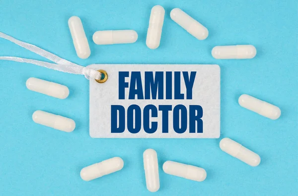 Medicine and health concept. There is a label on the table among the pills that says - FAMILY DOCTOR
