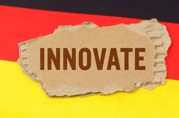 Üzleti Pénzügyi Koncepció Háttérben Német Zászló Fekszik Karton Felirattal Innováció — Stock Fotó
