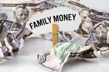 İş ve finans kavramı. Masada dolar var ve üzerinde kağıt olan bir mandal var - AİLE PARA