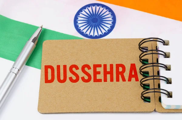 Holidays in India. Against the background of the flag of India lies cardboard with the inscription - Dussehra