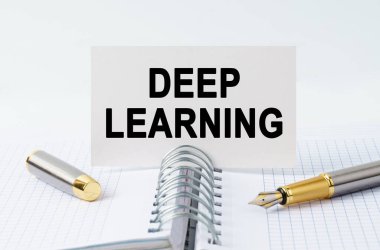 Finance and business concept. On the table is a notebook, a pen and a business card with the inscription - DEEP LEARNING