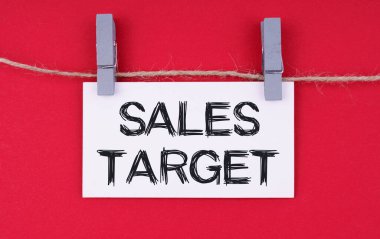 Business and economy concept. A business card with the inscription - SALES TARGET. Isolated on red background