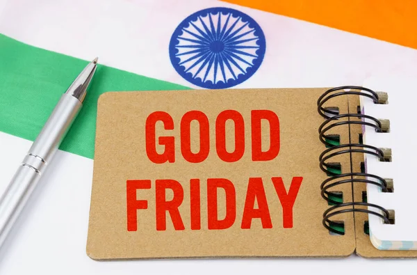 Holidays in India. Against the background of the flag of India lies cardboard with the inscription - good friday