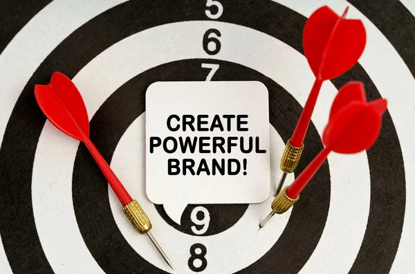Business and economy concept. There is a sign on the target that says - CREATE POWERFUL BRAND